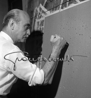 Lucio Fontana producing an artwork. 1960 